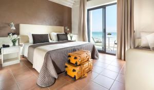 a bedroom with a bed with two boxes on the floor at Hotel Ambasciatori in Riccione