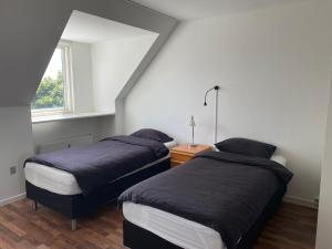 a bedroom with two beds and a window at Apartment with view in Birkerød +13 photos
