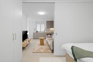 A bed or beds in a room at STAYY Flagship Limmattal - contactless check-in