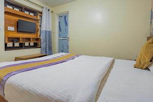 Voodi või voodid majutusasutuse OYO 821 Hotel Gauri toas