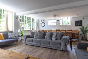 a living room with a couch and a table at The Coach House in Lea
