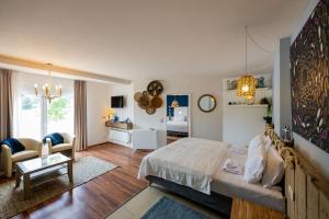 a bedroom with a bed and a living room at Rathener Hof by STEIGER Hotels in Kurort Rathen