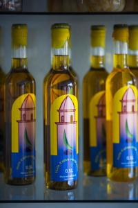 a group of bottles of alcohol on a shelf at Hotel Le Bon Port in Collioure