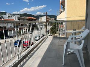 a balcony with a chair and a view of a city at HomeBak Hospitality in Xanthi