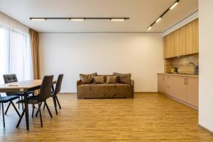 a living room with a table and a couch at Hotel Pid Strihoju in Bukovel