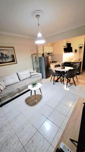 a living room with a couch and a table at SOLI Apartment in Neoi Epivates