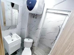 a bathroom with a toilet and a sink and a shower at SOLI Apartment in Neoi Epivates +25 photos