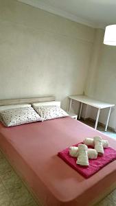 a large pink bed with two pillows on it at SOLI Apartment in Neoi Epivates
