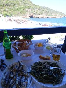 a table with seafood and a view of a beach at παραθαλασσιο σπιτι στην εξοχη in Tsakaíoi