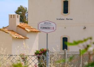 a street sign in front of a church at B&B Fermata 106 da Carolina in Siculiana Marina