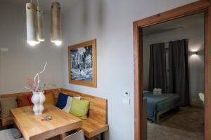 a living room with a table and a couch and a mirror at B&B Fermata 106 da Carolina in Siculiana Marina