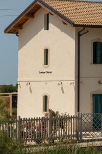 a house with a fence in front of it at B&B Fermata 106 da Carolina in Siculiana Marina