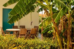 a dining room with a table and chairs and plants at B&B Fermata 106 da Carolina in Siculiana Marina