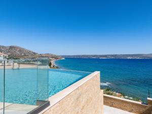 a swimming pool with a view of the ocean at Panorama Seaview Village at Kalyves in Kalyves