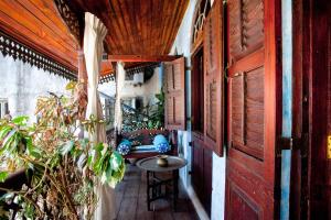 a balcony with a table and chairs in a house at Emerson Spice in Zanzibar City