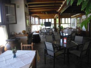 a restaurant with tables and chairs in a room at Camping Alpujarras in Laroles