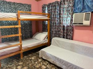 a bunk bed room with two bunk beds at Zia's Homestay in Siquijor