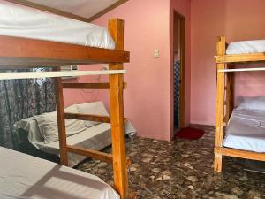 a room with two bunk beds in a room at Zia's Homestay in Siquijor