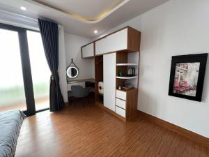 a living room with a bed and a desk at Oasis Homestay in Hoi An