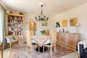 a dining room with a table and chairs at Villa Echauguette, Chambre et toilette privee Maison partagee avec la proprietaire in Six-Fours-les-Plages