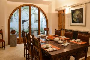 a dining room with a wooden table and chairs at Chambre d'Art in Dax
