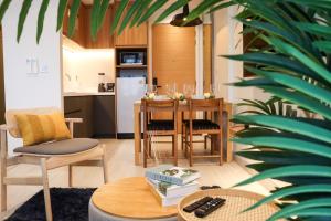 a kitchen and dining room with a table and chairs at Lakeside Residences by NLA in Bang Tao Beach