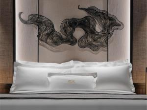 a bed with a head board with a painting on it at Pangkor Laut Resort - Small Luxury Hotels of the World in Pangkor +49 photos