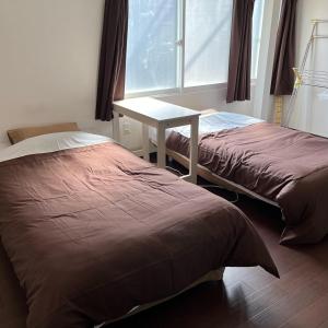 Ένα ή περισσότερα κρεβάτια σε δωμάτιο στο Otaru Eminabackpackers