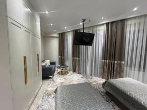 a bedroom with a bed and a tv on the wall at Guest House Uzbegim in Tashkent