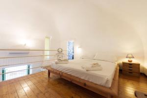 a bedroom with a large bed and a window at Corricella Hammok - Gioia Apartments in Procida