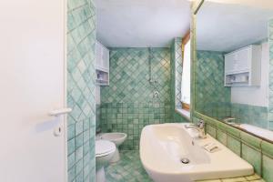 a bathroom with a sink and a toilet at Corricella Hammok - Gioia Apartments in Procida