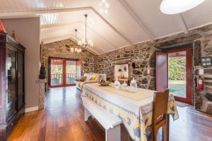 a large room with a stone wall with a bed at GuestReady - Quintinha casas do jardim 2 in Arcos de Valdevez