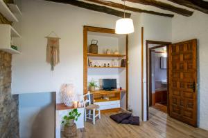 a room with a door and a desk with a television at Lo Mirador De Forès in Tarragona