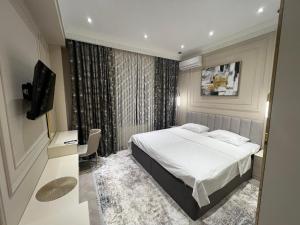 Ένα ή περισσότερα κρεβάτια σε δωμάτιο στο Guest House Uzbegim