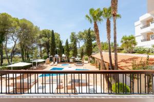 a view of a resort with a pool and palm trees at S'Argamassa Boutique Hotel in Santa Eularia des Riu