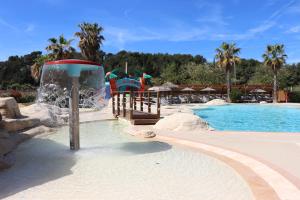 a pool with a water park with a water slide at Camping Mas De Pierredon in Sanary-sur-Mer