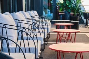 a row of tables and chairs in a restaurant at ESTIMAR Calpe Suitopia in Calpe
