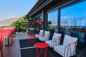 a bar with red tables and chairs on a balcony at ESTIMAR Calpe Suitopia in Calpe
