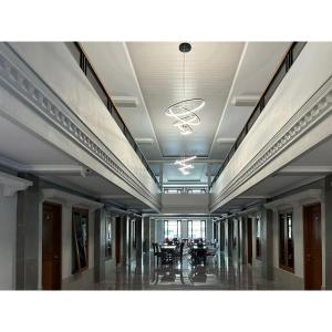a hallway with tables and chairs in a building at Urbanview TWH Costel near Stadion Maguwoharjo Yogyakarta in Yogyakarta