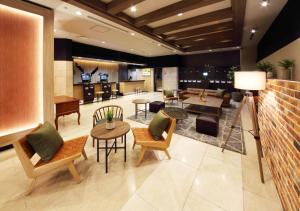 a lobby with tables and chairs and a bar at Takasaki Washington Hotel Plaza in Takasaki
