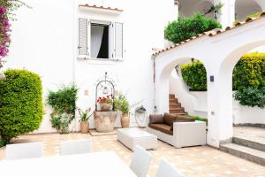 a white house with a patio with a couch at Villa Elena by MyVillaCollection in Capri