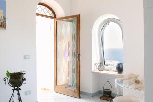 a room with a mirror and a table and a window at Villa Elena by MyVillaCollection in Capri +48 photos