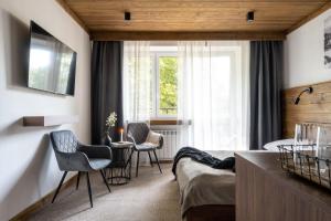 Televízia a/alebo spoločenská miestnosť v ubytovaní Apartamenty Krupówki 20