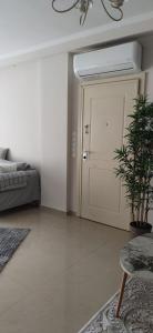 a bedroom with a bed and a door with a plant at Η πέρλα της λίμνης/ The lake's pearl in Ioannina +49 photos