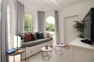 a living room with a couch and a window at Ostseeresidenz Appartements Wischuer Fewo 11 in Wischuer