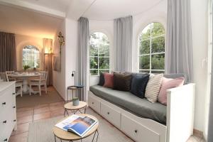 a living room with a couch and a table at Ostseeresidenz Appartements Wischuer Fewo 11 in Wischuer +39 photos