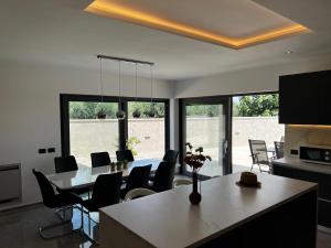 a kitchen and dining room with a table and chairs at Villa Mare - Modern villa with swimming pool and jacuzzi in Pula