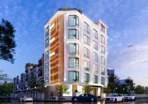 a tall white building with cars parked in front of it at Minh Hằng 5 Hotel in Thanh Hóa