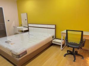 a bedroom with a bed and a desk and a chair at The Urbana Condo Pakkret in Pak Kret +6 photos