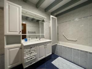 a bathroom with a sink and a tub and a mirror at Armanaga in Ainharp +30 photos